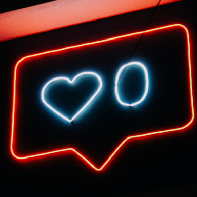 A neon sign featuring a love heart and the number zero. It looks like the Instagram likes icon.
